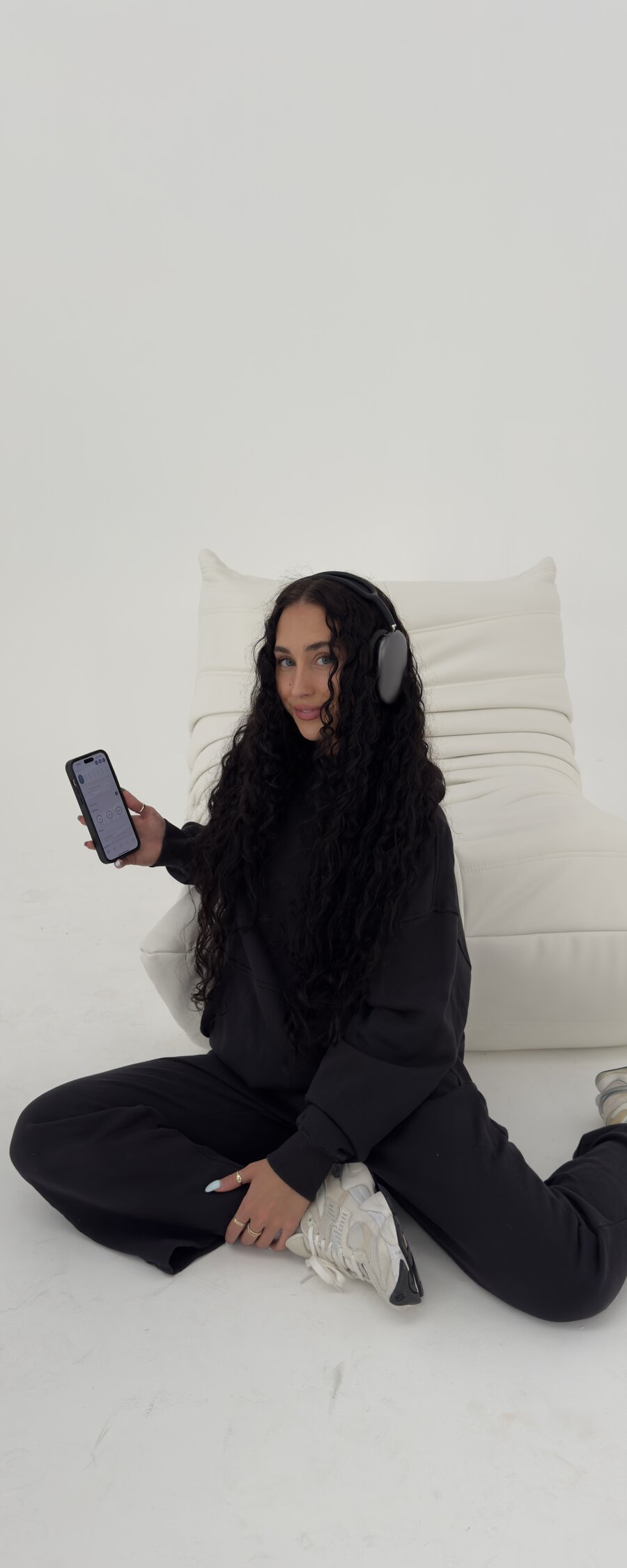 Content creator filming on location with headphones and phone